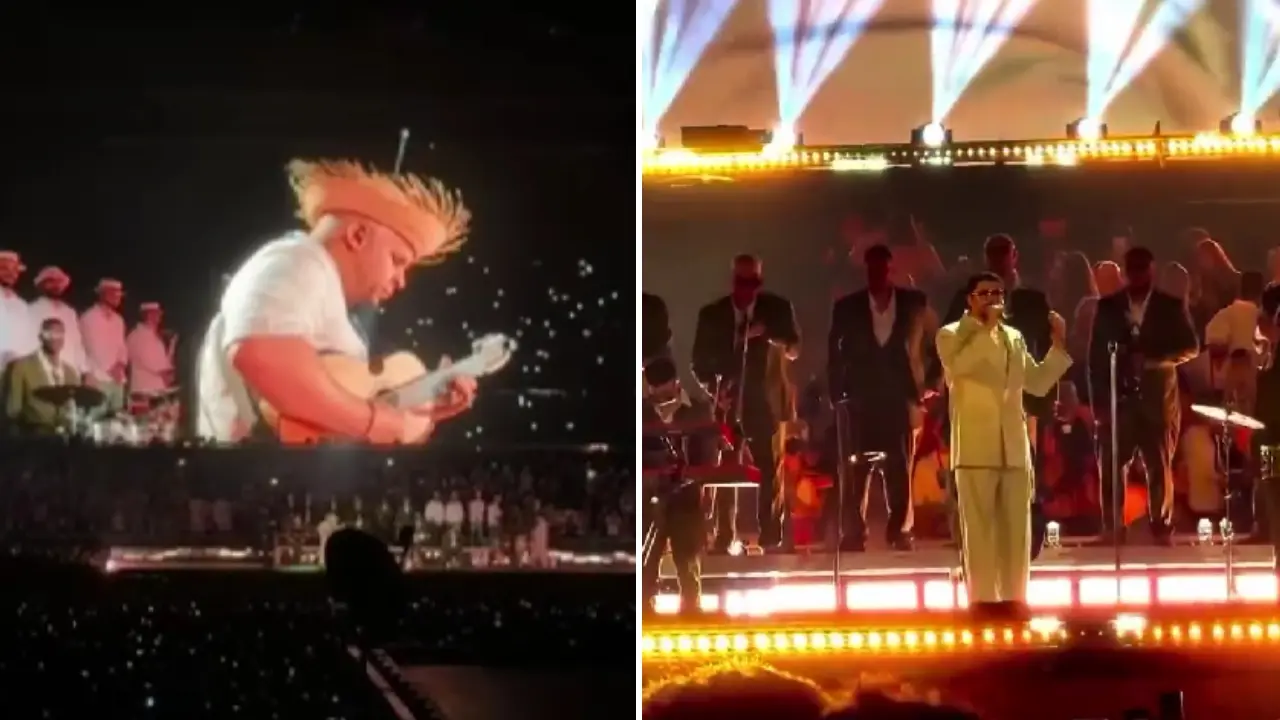 Bad Bunny en el escenario de Medellín tocando la guitarra mientras el público enciende linternas en homenaje a Yeison Jiménez