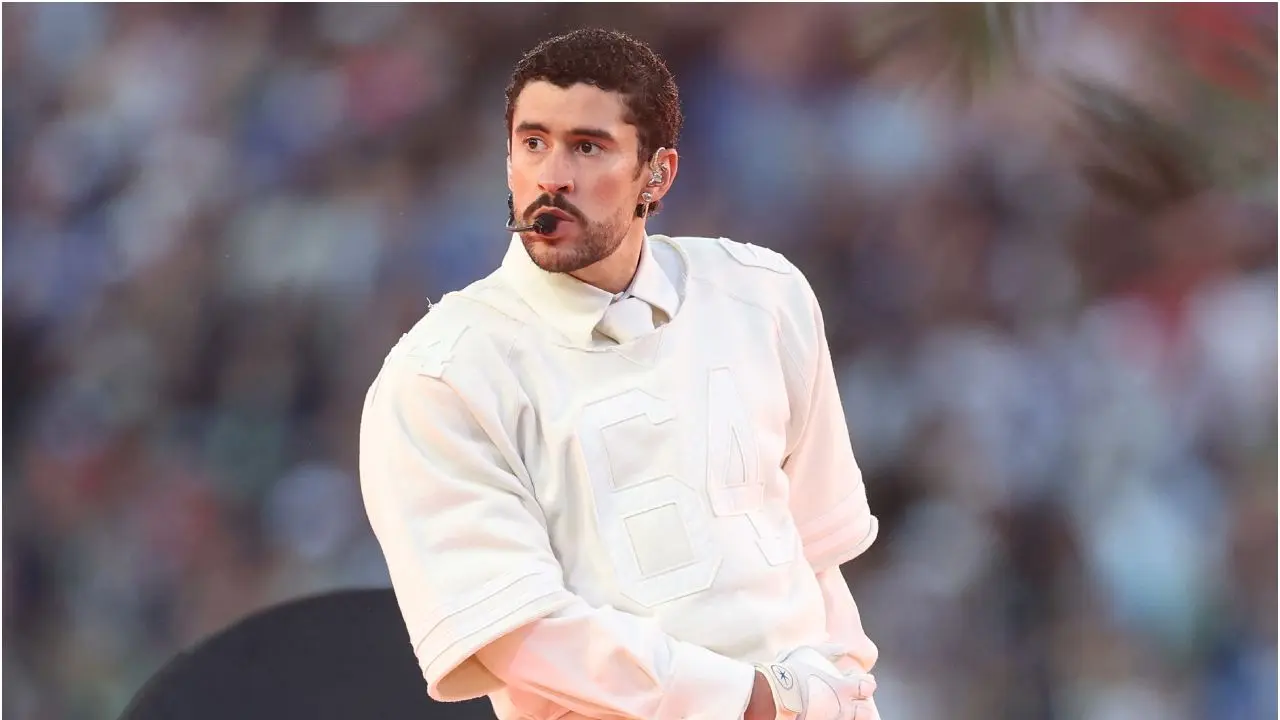Bad Bunny en el Super Bowl LVIII con traje blanco y balón de fútbol, celebrando la cultura latina con mensajes de identidad y resistencia