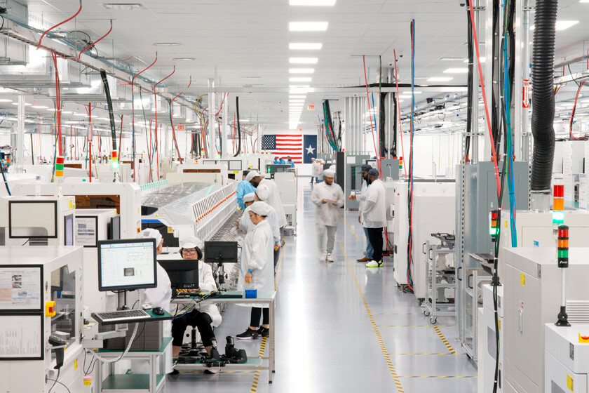 Línea de ensamblaje del Mac mini en la planta de Foxconn en Houston, Texas, con operarios trabajando en componentes tecnológicos