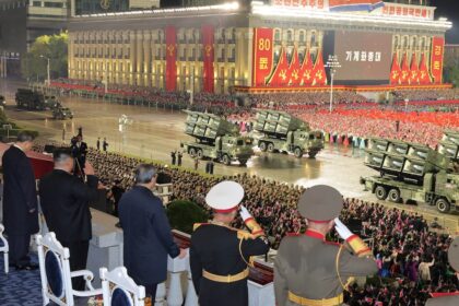 Kim Jong-un en el congreso del partido norcoreano, rodeado de la élite militar, con misiles balísticos de fondo simbolizando su arsenal nuclear irreversible