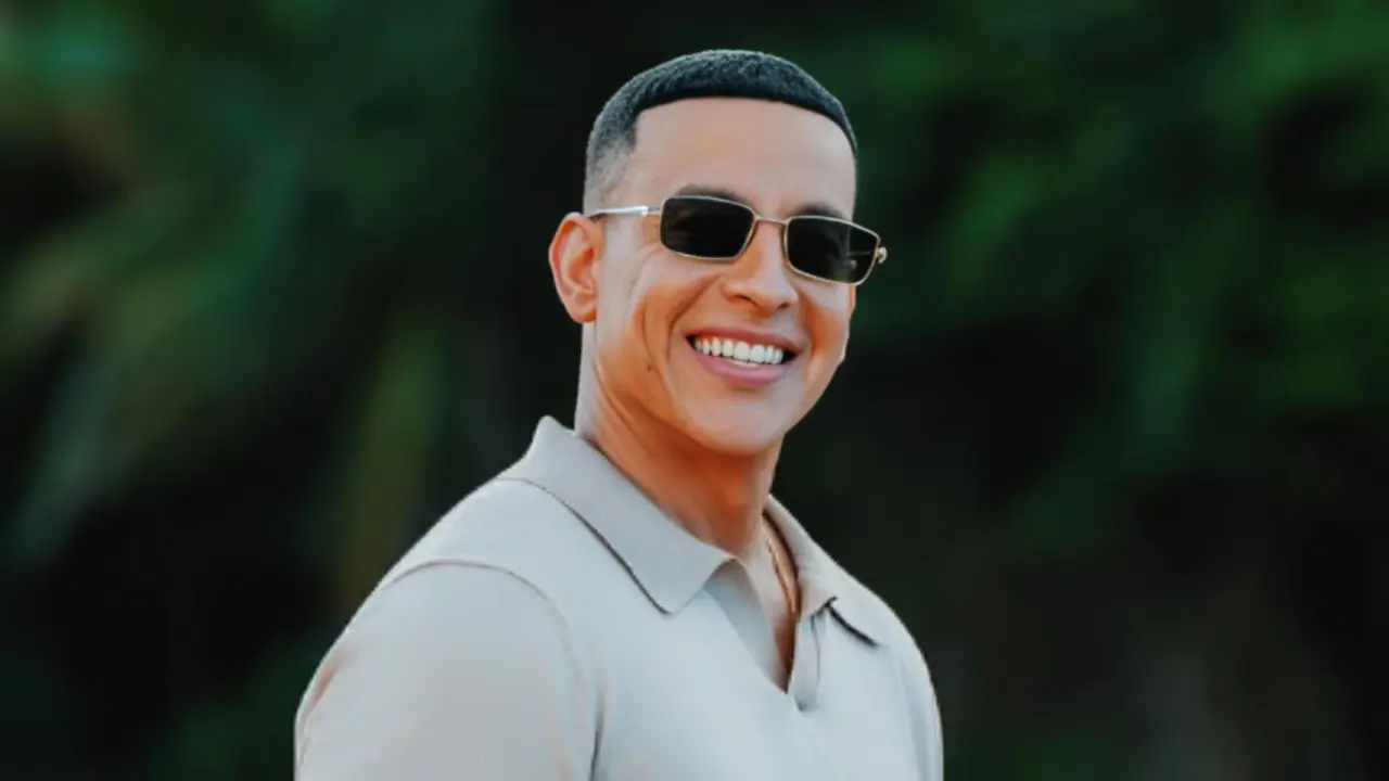 Daddy Yankee en un escenario con luces doradas, representando el homenaje de Puerto Rico con una carretera en su honor