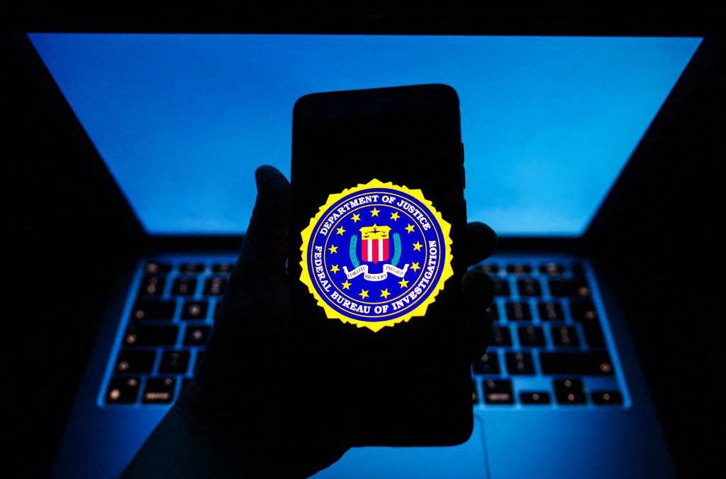 Pantalla de smartphone mostrando alerta del FBI sobre permisos sospechosos de apps chinas con iconos de contactos y ubicación en rojo