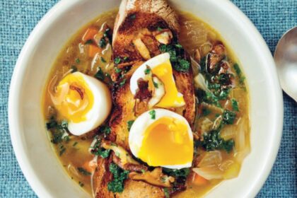 Sopa de shiitake con huevo cremoso de 6 minutos y perejil esmeralda escaldado, servida en bowl de cerámica con tallos de hongos tostados